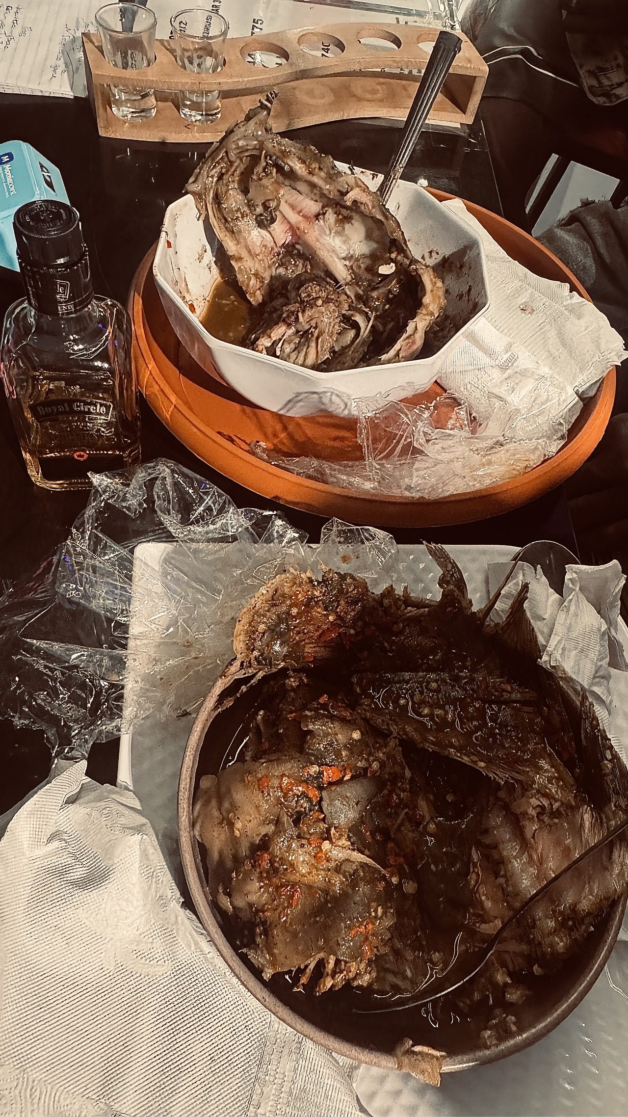 Grilled fish and peppered meat served in bowls on the table